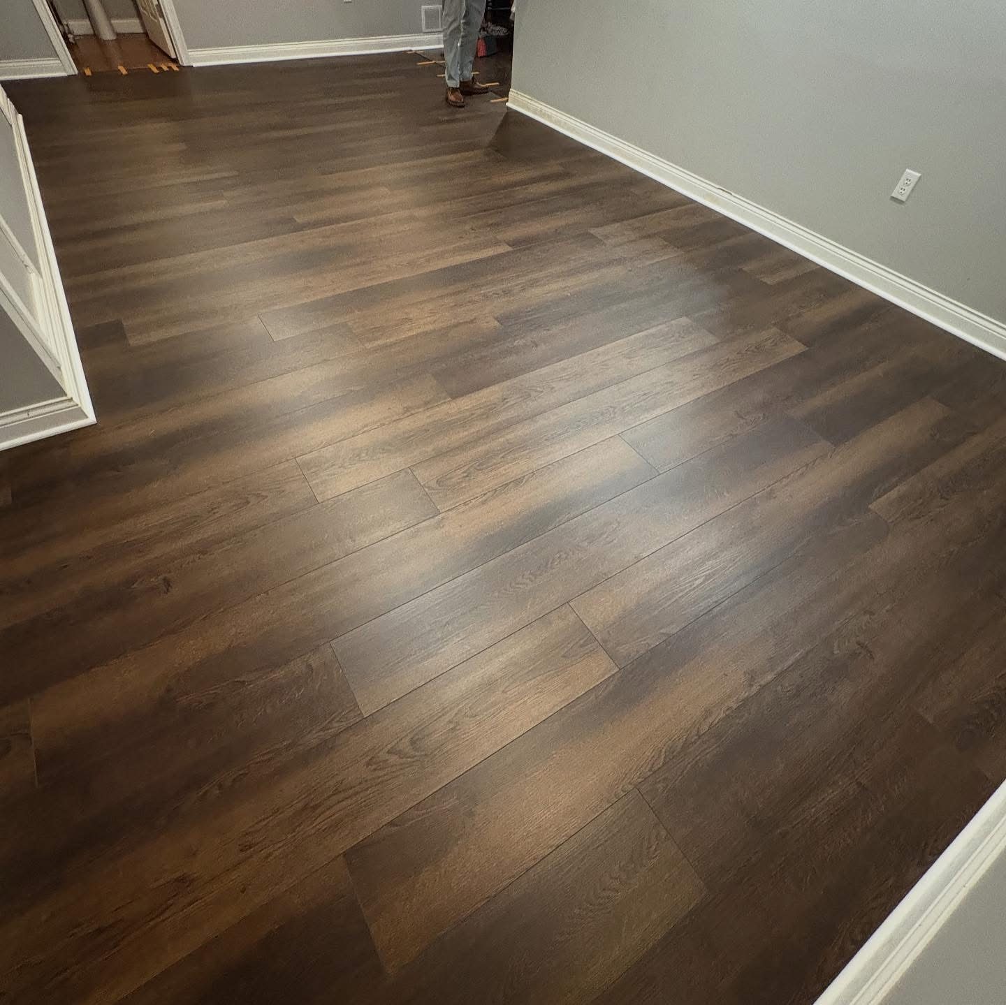 Dark walnut luxury vinyl plank flooring installed in a Dayton, OH bedroom