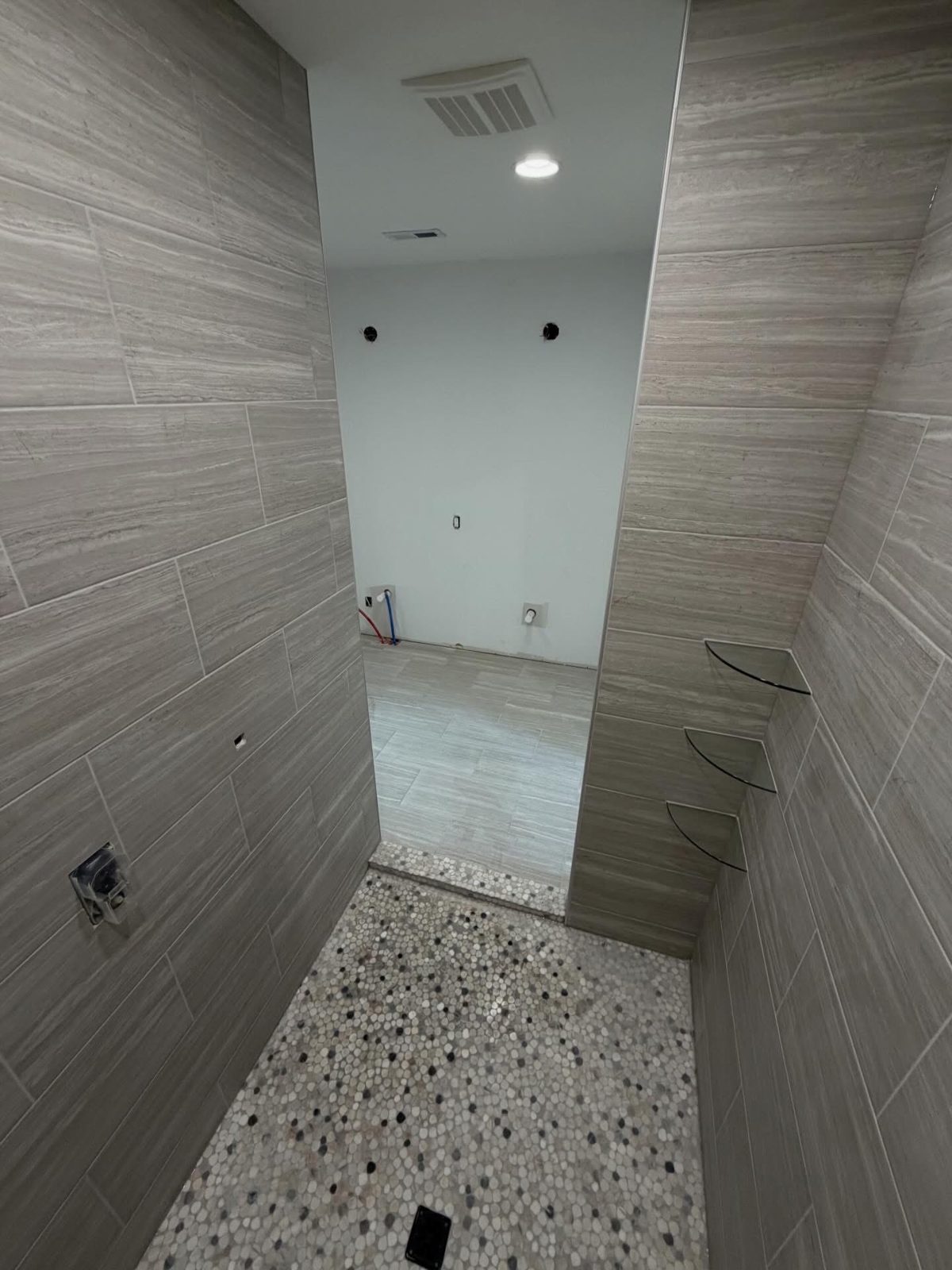 Gray tile walls paired with a terrazzo-look tile floor in Dayton, OH