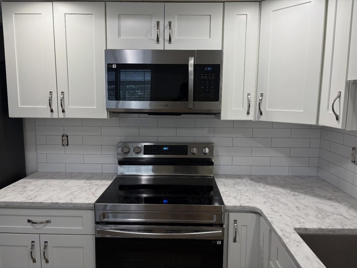 Gray tile backsplash paired with marble-look countertops