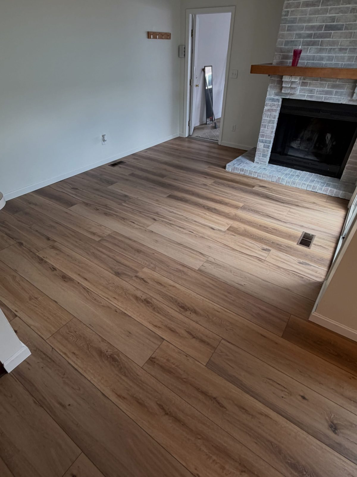 LVP flooring in a Dayton, OH family room with a brick fireplace