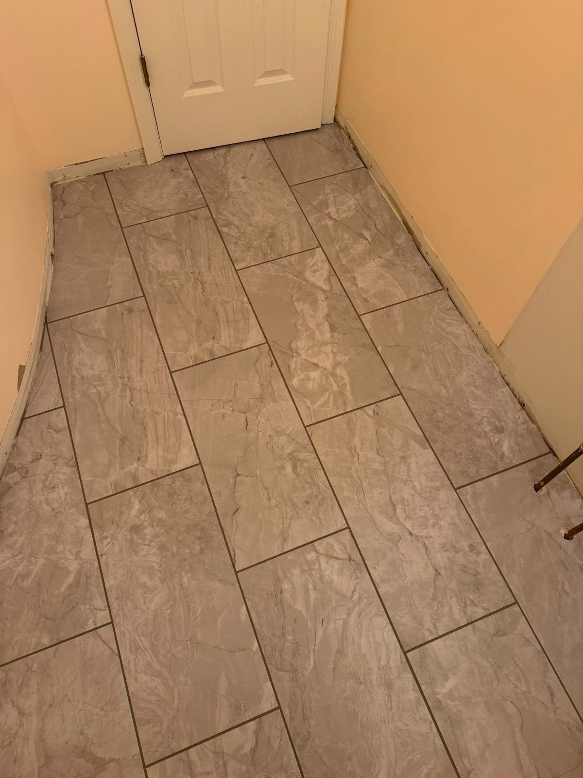 Travertine-look tile floor installed in a Beavercreek, OH entryway